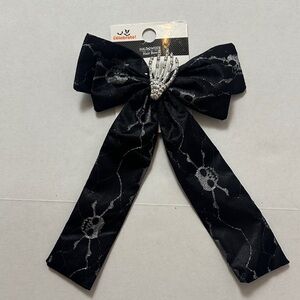 Celebrate! Black Halloween Bow Hair Clip with Rhinestone Skeleton Hand